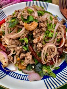 a white plate topped with meat and veggies