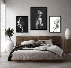 two black and white pictures hang on the wall above a bed in a minimal bedroom