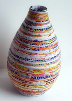 a colorful vase sitting on top of a white table