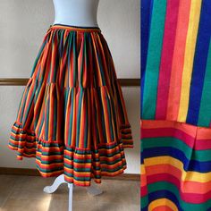 Gorgeous full circle rainbow skirt from the 70s! Pictured with a petticoat, not included -The only tag has a handwritten 30 on it -This feels like a cotton poly blend -Would fit a size small, 23" to 27" waist (maybe a tight 28") -Length: 29.5" Each side of the waist ties, so the waist is adjustable.  The ties can either be tied at the sides, or can be wrapped around each way and tied in the front and in the back.  There is no elastic and no other closures besides the ties.  The skirt is unlined. Very good vintage condition!  Clean and ready to wear. The only thing to note is light marking on part of the ties, but it's very faint and won't be seen when worn and ties are tied. This skirt is a wonderful piece and the colors are incredibly vibrant! All vintage items are unique and pre-loved, a Retro Full Skirt Petticoat With Ruffles, Spring Retro Petticoat, Retro Skirted Cotton Bottoms, Vintage Long Skirt Petticoat, Vintage Multicolor Long Skirt, Retro Cotton Tiered Skirt, Retro Cotton Skirt With Ruffles, Retro Cotton Skirt, Retro Fitted Skirt For Festival