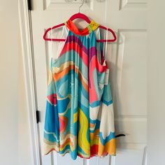 Never Worn. Size Large. Vibrant Print A-line Beach Dress, Multicolor A-line Sundress For Vacation, Multicolor Sleeveless Summer Party Dress, Multicolor Sleeveless Sundress For Party, Flowy Multicolor Sleeveless Dress For Spring, Multicolor Sleeveless Dress For Spring And Summer, Multicolor A-line Sundress, Chic Halter Neck Dress With Vibrant Print, Multicolor Sleeveless Dress For Vacation In Spring