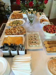 a table filled with lots of food and desserts