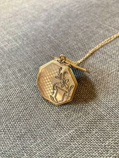 This beautiful small to medium sized octagonal shaped locket measures 1" tall and 1" wide. It comes on a new 20" 14kt gold filled chain with a spring clasp. This locket is in excellent vintage condition with only minor signs of wear and a little paper stuck in the inside which can be removed with goo gone or covered with photos.  1920s-1940s era.  Such a cute layering piece as well! Goo Gone, Locket Chain, Stripes And Floral, Geometric Jewelry, Gold Geometric, Locket Necklace, Gold Filled Chain, 14kt Gold, Locket