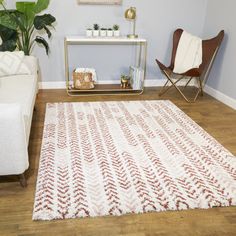 a living room filled with furniture and a white rug