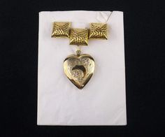 Antique 12k Gold Over Sterling Silver Pin and Memory Keeper Heart Locket Pendant Hearken back to the 1950s with this stunning piece of jewelry. Wear it as they did back then on your blouse or jacket as a pin with the locket attached, or wear the locket separately with your favorite gold chain. This women's jewelry is masterfully engraved floral and crescent moon design on the front of this locket, Inside the locket, markings are 1/20 "12k G.F. on Sterling". Weight is 8 grams. Never worn, in old Vintage Heart-shaped Brooch Jewelry, Vintage Heart Shaped Brooch Jewelry, Vintage Heart Shaped Brooch, Vintage Brooch Jewelry For Valentine's Day, Vintage Brooch For Valentine's Day, Vintage Valentine's Day Jewelry Brooch, Victorian Hallmark Jewelry For Wedding, Victorian Wedding Jewelry With Hallmark, Valentine's Day Gold Brooch Jewelry