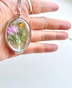 sterling silver Large oval Beveled glass locket necklace, oval hollow glass locket necklace, heirloom glass locket with inside space, Wedding ring locket Please note that these are the sterling silver version of the larger size (40mm) beveled glass lockets with 6mm space inside so you can add stones or plain gold band rings inside (To give you an idea, you can fit 4 USD quarters inside). I have another listing for smaller size (20 mm) glass lockets with the same 6mm in depth. The oval one is 30* Unique Silver Keepsake Jewelry, Unique Oval Jewelry For Memorial, Spiritual Pendant Jewelry With Pressed Flowers, Silver Dainty Locket Necklace For Keepsake, Sterling Silver Oval Locket Necklace, Nickel-free, Handmade Victorian Jewelry With Oval Pendant, Oval Sterling Silver Locket Necklace Nickel Free, Oval Sterling Silver Nickel-free Locket Necklace, Handmade Victorian Oval Pendant Jewelry