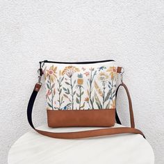 "FLOWER GARDEN" - Natural white cotton crossbody bag. - Medium or Small bag  - Water repellent canvas - Suitable have any clothes - Strong and pleasant to carry bag - Natural material from nature - Medium  bag, but with good internal volume - Hand made colorful print on the front - Hardware color silver Made of Thick natural White cotton.  Combined with vegan leather - Camel color. Two outer pockets on the front side - for size Medium only. Universal bag for your everyday life, for sport, for th Spring Canvas Crossbody Shoulder Bag, Floral Print Shoulder Bag For Everyday Use, Spring Canvas Crossbody Bag For Daily Use, Daily Use Spring Crossbody Canvas Bag, Bohemian Canvas Bag For Everyday Spring Use, Spring Hobo Pouch Bag For Everyday Use, Floral Print Crossbody Shoulder Bag For Everyday Use, Everyday Floral Print Crossbody Shoulder Bag, Beige Floral Print Shoulder Bag For Everyday Use