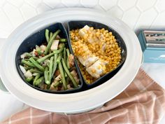 two containers filled with food sitting on top of a table