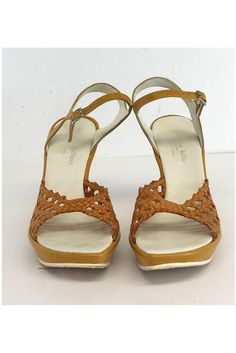 Size 7 Gold Woven Cut Out Leather Wedges Made in France Adjustable ankle straps w/silver-tone buckle In sole wear Some out sole wear Platform height 1" Heel height 4" Insole length 9.5" Fitted Summer Heels With Leather Sole, Fitted Closed Toe Sandals With Buckle Closure, Fitted Strappy Heels With Round Toe, Fitted Ankle Strap Sandals With Leather Sole, Spring Sandals With Leather Sole, Fitted Leather Sandals With Ankle Strap, Fitted Ankle Strap Leather Sandals, Fitted Brown Closed Toe Sandals, Vintage Sandals With Ankle Strap Medium Width