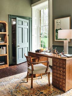 an office with a desk, chair and bookshelf