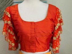 ❥ Handmade Designer stitched blouse ; Can be used for sarees / Lehengas. ❥ Ready to ship (Price mentioned is for Size 36-40)  ❀❀ Return / Exchange Policy :  ※ No Return/ No Exchange / No Cancellation! ※We need proof of video while package is opening for considering any case of missing or damaged products ;  ※ We can not accept any returns , if video at the time of package opening is not provided by the client . ღ ღ Please be courteous and don't ask for negotiation on prices ! We define prices based on material & efforts involved to deliver this high quality product! We use all High Quality handcrafting !  Care Instructions :  1.Dry Wash Only , preserve the blouses in cloth bag to maintain the shine and quality;  NOTE TO OUR BELOVED CLIENTS : We do not buy / sell used items. We do not excha Orange Bollywood Blouse For Navratri, Bollywood Style Orange Unstitched Blouse, Orange Bollywood Style Unstitched Blouse, Bollywood Style Orange Blouse For Diwali, Orange Bollywood Blouse For Diwali, Festive Orange Bollywood Blouse, Orange Self Design Blouse For Navratri, Art Silk Blouse Piece With Gota Work In Gold, Orange Blouse With Zari Work For Navratri