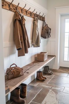 an entryway with several coats and shoes hanging on the wall