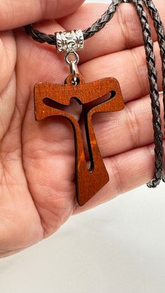 The necklace with the Franciscan Cross is a symbol of the dignity of the children of God, because it is the Cross that has sustained Christ. The Tau "T" is the last letter of the Hebrew alphabet. ... The meaning given to the Tau Cross is similar to that of the Latin Cross. It represents Christian devotion, a sign of penance, redemption and protection from God and redemption in Christ. It is a perfect gift for every Christian PRODUCT DETAILS: This leather necklace measures 20 inches long, or you can choose the size you need, the wooden cross measures 1.7 inches, if you want another size I will gladly do it, please send me a message with the measurement you need, it will be an honor work for you!! All our pieces are completely handmade so there may be a small difference between them, no two Symbolic Necklace For Father's Day Gift, Symbolic Crucifix Cross Necklace As Gift, Symbolic Cross Necklace Gift, Symbolic Cross Necklace As Gift, Brown Cross Pendant Necklace For Gift, Brown Cross Pendant Necklace As Gift, Crucifix Necklace For Father's Day Gift, Symbolic Cross Pendant Necklace As Gift, Father's Day Gift Crucifix Necklace