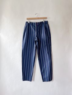 Stunning 90s navy blue stripe pants, style with a white tank or your favorite band tee. Love the slouchy oversided look on them!  100% cotton CONDITION: In great vintage condition. Missing one botton  MEASUREMENTS: Tagged size 6, but see measurements below: Laying flat Waist: 15.5 inches Hips: 21 inches Rise: 11 inches Inseam: 30 inches Length: 41 inches Any questions regarding this listing, please dont hesitate to contact via DM. Please note these items are vintage/ second hand, they will have some signs of wear. If any major damage, it will be mentioned on the listing description. No returns or exchanges allowed Follow Sue's Market on Instagram @sues.mkt for daily updates, sneak peeks on new finds, and daily style inspo. Cotton Loungewear Bottoms With Three Stripes, Summer Cotton Bottoms With Three Stripes, Wide Leg Cotton Pants With Three Stripes, Casual Straight Leg Pants With Vertical Stripes, Cotton Pants With Three Stripes And Relaxed Fit, Wide Leg Cotton Pants With Contrast Stripes, Casual Cotton Pants With Three Stripes, Wide Leg Pinstripe Cotton Pants, Spring Relaxed Fit Pants With Three Stripes