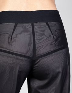 TECHNOCRACYBlack transparent tulle flared pants w/ yoke. Separate Bermuda lining trousers in grey/silver included. Concealed zip in the side seam of both trousers.Upper fabric 100% synthetic fiberLining 100% acetateModel wears size S*Available in blackFront length: 99cmBlack length (excl. waistband): 100cmInner leg seam: 83cmWaistband: 5cmWaist circumference: 79cmHem circumference: 62cm Sheer Micro-elastic Mesh Bottoms, Elegant Sheer Mesh Bottoms, Sheer Stretch Wide Leg Pants, Fitted Nylon Wide Leg Pants, Fitted Wide Leg Nylon Pants, Elegant Stretch Mesh Bottoms, Black Stretch Polyamide Bottoms, Stretch Black Polyamide Bottoms, Stretch Nylon Pants For Workwear