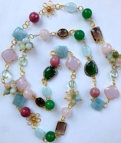 "This spectacular long multi gemstone statement necklace is a whimsical fun fantasy piece handmade and designed by me.  It is made  with 14K gold filled wire and chain, 24K vermeil flower connectors, and links, onto which I carefully wire wrapped the finest quality semi precious gemstones in spring pastel colors, including Flower clusters of Beryl, Rose Quartz faceted rounds, rhodonite faceted rounds,bezel set smokey quartz connectors, 24K gold vermeil connectors in two distinct shapes, square s Crazy Necklaces, Green Statement Necklace, Multi Gemstone Necklace, Freshwater Pearl Drop Earrings, Bijoux Fil Aluminium, Diy Jewelry Necklace, Wire Necklace, Quartz Beads, Necklace Long