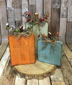 three wooden containers with plants in them sitting on a wood table next to a wall