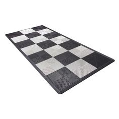 a black and white checkered rug on top of a floor with no one in it