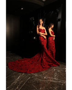 Red Corset & Fish-Cut Lehenga Set - Bora Honey's Dive into glamour with this red mermaid-style lehenga featuring a show-stopping big trail and a chic corset blouse. The corset neckline adds a touch of sophistication, while the ensemble is embellished with elongated sequins, Swarovski crystals, and sequins, ensuring a mesmerizing and opulent look that defines elegance and style. Included in Purchase: Mermaid Style Lehenga with Big Trail, Corset Blouse Product Specification Color: Red Fabric: Tull Red Mermaid Hem Gown With Sweep Train, Red Mermaid Gown With Sweep Train, Glamorous Red Fishtail Gown, Red Mermaid Fishtail Dress For Gala, Red Mermaid Dress For Wedding, Red Festive Evening Dress For Red Carpet, Glamorous Red Mermaid Dress For Red Carpet, Glamorous Red Mermaid Dress For Wedding, Fitted Red Sharara For Evening