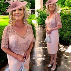 two women in pink dresses and hats posing for the camera