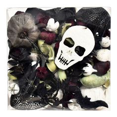 a skull surrounded by flowers and other items