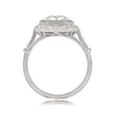 This ring features a 2.04-carat old European cut diamond, I color, and SI2 clarity. The center stone is surrounded by a halo of old mine and baguette-cut diamonds, and additional diamonds are set along the shoulders. The total weight of the additional diamonds is approximately 0.87 carats. This ring is handcrafted in platinum, with an openwork under-gallery and triple-wire shank.
The measurements of this ring are approximately 12.71mm x 12.55mm, including the halo.
This ring is currently sized a Platinum Cluster Ring With Baguette Cut Center Stone, Platinum Marquise Cut Diamond Ring With Halo Setting, Platinum Diamond Ring With Marquise Cut In Halo Setting, Classic Baguette Cut Halo Ring, Platinum Baguette Cut Halo Ring, Platinum Halo Ring With Asscher Cut Center Stone, Asscher Cut Platinum Halo Ring With Center Stone, Platinum Asscher Cut Halo Ring, Heirloom Platinum Diamond Ring With Halo Design