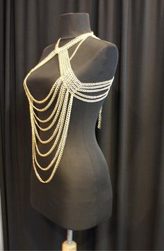 Here's a great and totally unique body chain necklace that makes the old 'little black dress' take on a whole different meaning! This gold body chain as I like to call it, adds the perfect amount of deco to your once all too simple party dress. It also looks great worn over a loose shirt, with jeans, conforming to the body in all the right places. Its great for a cocktail party or a night out at the clubs, this is definitely an attention grabbing piece. Would you like to see more body chain jewe Gold Bohemian Body Chain For Festivals, Bohemian Gold Body Chain For Festivals, Gold Choker Jewelry For Night Out, Festival Clavicle Chain Necklace, Summer Party Body Chain With Clavicle Detail, Glamorous Festival Jewelry With Chain Detail, Glamorous Gold Body Chain With Chain Strap, Bohemian Party Chain Necklace With Adjustable Chain, Glamorous Gold Body Chain For Festivals