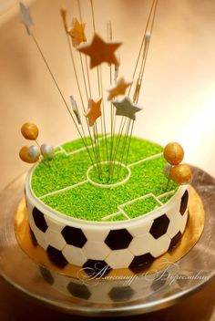 a cake decorated with soccer balls and pins