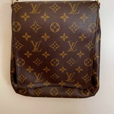 Pre-Owned, Gently Used Vintage Louis Vuitton Shoulder Bag ( See Photos). Outside Is Extremely Clean And There Are A Few Ink Marks Inside. Description: Brown Coated Canvas Lv Monogram Brass Hardware Leather Trim Single Adjustable Shoulder Strap Leather Trim Embellishment Alcantara Lining & Single Interior Pocket Snap Closure At Front Estimated Item Measurements: Base Length: 8.5 In Height: 9.5 In Width: 1.75 In Drop: 10.25 In Lv Monogram Bag, Photos Outside, Lv Monogram, Louis Vuitton Shoulder Bag, Brown Coat, Vintage Louis Vuitton, Brass Hardware, Leather Trim, Brown Gold