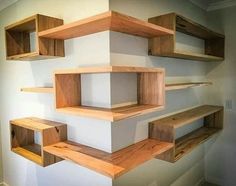 several wooden shelves on the wall in a room