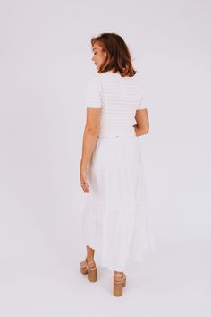 Get ready to turn heads in our White Out Dress! With a stunning crochet bodice and a textured tiered skirt, this dress is perfect for any summer occasion. Whether you're dancing the night away or just enjoying a day out, this dress will make you look and feel amazing. So go ahead, show off your unique style and be the life of the party! Details Crochet bodice Textured tiered skirt Short puff sleeve Maxi length Off white color Sizing Approximate measurements: SIZE LENGTH BUST S 55" 30" M 55" 33" Flowy Tiered Dress For Summer, Summer Maxi Dress With Lace Trim And Tiered Skirt, Flowy Tiered Midi Dress For Vacation, Flowy Tiered Maxi Dress, Flowy Tiered Summer Dress, Fitted Tiered Skirt Maxi Dress For Vacation, Flowy Tiered Dress With Layered Hem, Fitted Layered Tiered Dress, White Breezy Tiered Maxi Dress