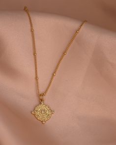 The Kristin necklace is the perfect balance of simple and gorgeously detailed. Delicate, yet bold, this stunner glimmers in the sunshine and is a beautiful addition to your Stavi Sol collection. Chain 24K Gold Filled Beaded Rolo Chain Length: 17” inches Pendant: 24K Gold Filled with cz detail 14mm x 13mm Spiritual Necklace With Beaded Chain And Round Pendant, Spiritual Beaded Chain Necklace With Round Pendant, Bohemian Gold Crystal Necklace With Delicate Chain, Elegant Medallion Necklace With Pearl Chain, Gold Temple Necklace With Pearl Pendant For Gift, Gold Necklace With Beaded Chain And Round Pendant, Gold Pendant Chain Necklace With Beaded Detail, Gold Pendant Chain Necklace With Beaded Chain, Spiritual Pendant Necklace With Pearl Chain