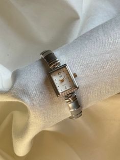 Vintage two toned dainty watch with a small square face. link band, links can be taken off by jeweler or if you have a watch adjuster set at home! makes a gorgeous accessory ✨ amazing condition! see photos for measurement VINTAGE WATCHES: All watches are finely sourced, hand picked and come as is with expected signs of minor wear! because the watches are older, most don't work but some may just need a new battery. Watches are untested & are meant for the aesthetic and to accessorize :)  Watch is currently NOT ticking Small Square Watch, Dainty Watch Aesthetic, Silver Square Watch With Metal Dial, Elegant Silver Watch With Square Face, Silver Rectangular Metal Watch, Rectangular Silver Metal Watch, Timeless Silver Square Watch, Elegant Silver Square Watch, Dainty Watch Silver