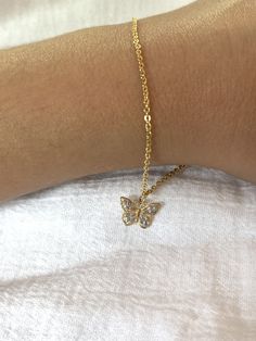 Give her the gift of wings with this beautiful mini butterfly bracelet.DETAILS- 14k yellow gold butterfly charm bracelet with rhodium plating and rose rhodium- Chain style may vary slightly- Handmade in our New York City studioVARIATIONSIf you require any variation of this style (a different style chain, longer bracelet, color options etc.) feel free to message us. We will do our best to accommodate you. Additional costs may apply depending on the variation.POLICYThis item is made to order. Made Delicate Gold Plated Jewelry With Butterfly Charm, Gold Metal Jewelry With Butterfly Charm, Dainty Gold-plated Jewelry With Butterfly Charm, Gold Butterfly Charm Bracelet, Butterfly Charm Bracelet, Gold Butterfly, Butterfly Charm, Chain Styles, Rhodium Plated