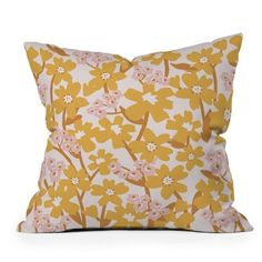 a yellow and white pillow with pink flowers on it's side, against a white background