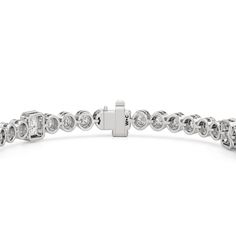 A sweeping sense of sophistication is deeply embedded within this tennis bracelet's timeless design. Bezel-set radiant and round diamonds line up to form a pattern, leading the eye from one flash of sparkle to another. Fastening the bracelet onto your wrist is a secure tongue-and-clip clasp. Radiant Bezel, Blue Wedding Band, Something Blue Wedding, Diamond Anniversary Rings, Mens Band, Something Blue, Style Gift, Tennis Bracelet, A Pattern