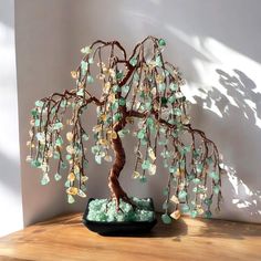 a bonsai tree sitting on top of a wooden table