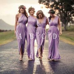 four women in purple dresses walking down the road