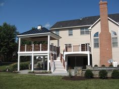 a two story house with stairs leading to the second floor