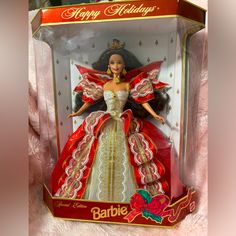 a barbie doll in a red and white dress with gold trimmings on it's chest