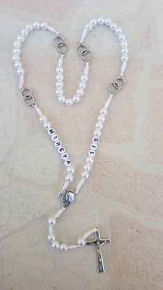 Wedding rosary with a name for newlyweds. If you want to brighten up someone's wedding day and give them a personal gift, you can order a wedding rosary with a name. This rosary come with two names, bride and groom (one on the right and the other on the left side of the rosary). See pictures! This beautiful rosary it's perfect gift for wedding. It's made with white resist cord and beautiful white pearl. In every decade is two rings what symbolizes weddings. Its made with medal Virgin Mary and cr Customizable Spiritual Jewelry For Weddings, Customizable White Jewelry For Wedding Gift, White Spiritual Jewelry With Custom Name, Customized White Wedding Necklaces, Custom Name White Jewelry For Wedding, Customized White Wedding Necklace, Custom Name White Spiritual Jewelry, Personalized White Necklace For Wedding Gift, White Miraculous Medal Necklace For Wedding