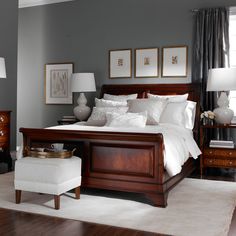 a bedroom with gray walls and white bedding