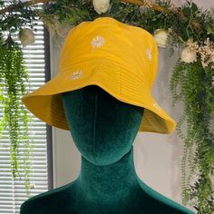 To Compose The Most Casual, Simple, And Neutral Looks, The Bucket Hat Comes In As An Accessory That Will Balance The Look, Bringing A Splash Of Color With Fun Patterns And Textures Like This Daisy Bucket Hat By 8 Other Reasons Trendy Yellow Wide Brim Bucket Hat, Yellow Beach Bucket Hat, Trendy Yellow Sun Hat With Curved Brim, Trendy Yellow Bucket Hat For Summer, Trendy Yellow Bucket Hat For Beach, Trendy Yellow Beach Bucket Hat, Trendy Yellow Sun Hat For Summer, Casual Yellow Bucket Hat, Trendy Yellow Bucket Hat For Spring