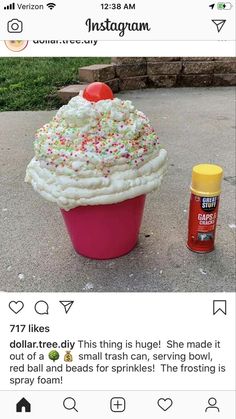 a cupcake with sprinkles on top is sitting next to a spray bottle