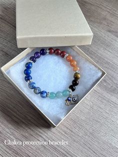 Protect and balance your energy field with this genuine gemstone chakra bracelet. Comes with evil eye and hamsa charms. Your choice of silver or gold charms and spacers. Gemstones include: Amethyst, Lapis Lazuli, Blue Spot Jasper, Green Aventurine, Tiger's Eye, Orange Aventurine, Red Jasper. Made with durable, stretchy elastic chord.  One size fits most. *Due to the nature of natural gemstone beads, some minor imperfections and slight color variations are to be expected.* Blue Spot Jasper, Essential Oil Gift Set, Orange Aventurine, Lapis Lazuli Blue, Essential Oils Gifts, Bottle Earrings, Hamsa Charm, Silver Eye, Hippie Bracelets