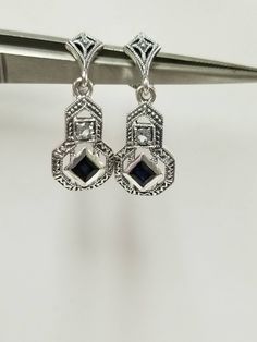 "Thanks for shopping our vintage estate store. We tend to sell well below wholesale and truly hope you enjoy all of our items. Many of the items are one of a kind, so please enjoy scrolling through the pictures and hopefully something will catch your eye. Brown spots are from reflections or the camera. Beautiful estate 925 sterling silver created .25ct sapphire with cz diamond earrings. Beautiful blue color, vintage style. Retailed: $149 on sale $86 Length: 7/8\" Width: 3/8\" 9mm Weight: 2.95 gr Vintage Sterling Silver Diamond Earrings For Anniversary, Vintage White Gold Dangle Jewelry, Vintage Sterling Silver Diamond Earrings For Formal Occasions, Silver Art Deco Diamond Earrings With Accents, Vintage White Gold Diamond Earrings, Vintage Sterling Silver Jewelry With Diamond Accents, Vintage Diamond White Drop Earrings, Vintage Dangle Jewelry With Diamond Accents, Vintage Pierced Diamond Earrings