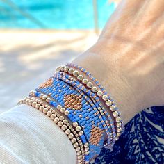 Pretty in Periwinkle Beaded Bracelets Band: Flat woven; 1/2"w; 14K yellow/rose gold-filled or sterling silver clasp & 1" extender chain; glass seed beads. Strands: Stretch style; 14K yellow/rose gold-filled or sterling silver round 2mm, 3mm & 4mm beads; glass seed beads. Wrap: Stretch style that will wrap around the wrist 3 times (can also be worn as a necklace); glass seed beads. (When adding to cart, select your single bracelet size, and it will be multiplied in length by three when made). Sho Dainty Blue Round Bead Bracelets, Blue Tiny Beads Stretch Bracelet For Friendship, Adjustable Blue Friendship Bracelets With Gold Beads, Blue Braided Bracelets With Tiny Beads As Gift, Adjustable Rose Gold Beaded Bracelets, Blue Bracelets With Gold Beads In Dainty Style, Blue Bracelets With Tiny Round Beads, Dainty Adjustable Blue Beaded Bracelets, Dainty Blue Adjustable Beaded Bracelets