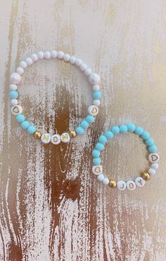 "This is a simple but elegant looking MOMMY & BABY bracelets. The bracelets are made with quality stretchy elastic and acrylic gumball beads. The gold mini spacer beads with gold letter beads are perfectly match for each other. This is the perfect baby shower gift for your best girlfriend, your wife or your daughter who is about to have a baby! You can have any names/words on the bracelets! Having a baby Boy? Check out our boy styles here 👉🏻 https://etsy.me/3dfziz6 🌟 Special Edition of Mo Personalized White Flexible Bracelets, Personalized Flexible White Bracelets, Flexible White Stretch Bracelet As Gift, White Stackable Name Bracelet For Birthday, White Stretch Bracelet With Letter Beads For Birthday, White Stackable Stretch Bracelet For Birthday, White Adjustable Stretch Bracelet For Personalized Gift, Cute White Stretch Bracelet For Personalized Gift, White Round Beads Stretch Bracelet For Birthday