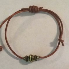 Brown Leather Cord With Silver Tone Metal Beads. Casual Brown Metal Bracelets, Casual Brown Metal Bracelet, Everyday Metal Bracelets With Sliding Knot, Adjustable Brown Jewelry With Silver Beads, Brown Bracelet With Silver Beads, Brown Silver Beads Bracelet Jewelry, Brown Silver Beaded Bracelet, Casual Silver Leather Bracelet, Adjustable Bracelet With Silver And Metal Beads