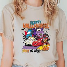 Title: Lightning McQueen Cars Halloween T-shirt, Truck or Treat T-shirt, 95 Cars McQueen T-shirt,Disney Halloween T-shirt ,Lightning Hallowheel Tee Brand Detail: Introducing the soft and stylish Gildan 64000 Fitted T-Shirt, made with 7.5 oz. of 100% cotton. It's got a specific Euro Pattern with a fashion fit in the neck, shoulders and sleeves. The 64000 Fitted T-shirt is one of Gildan's most popular additions to their incredible line up of inexpensive and high-quality garments. With new slim fit Disney Halloween Fan Merchandise T-shirt, Disney Halloween Graphic Print T-shirt, Disney Halloween T-shirt With Character Print, Disney Halloween Character Print T-shirt, Lightning Mcqueen, Disney Halloween, Fashion Fits, Halloween Tshirts, Top Styles